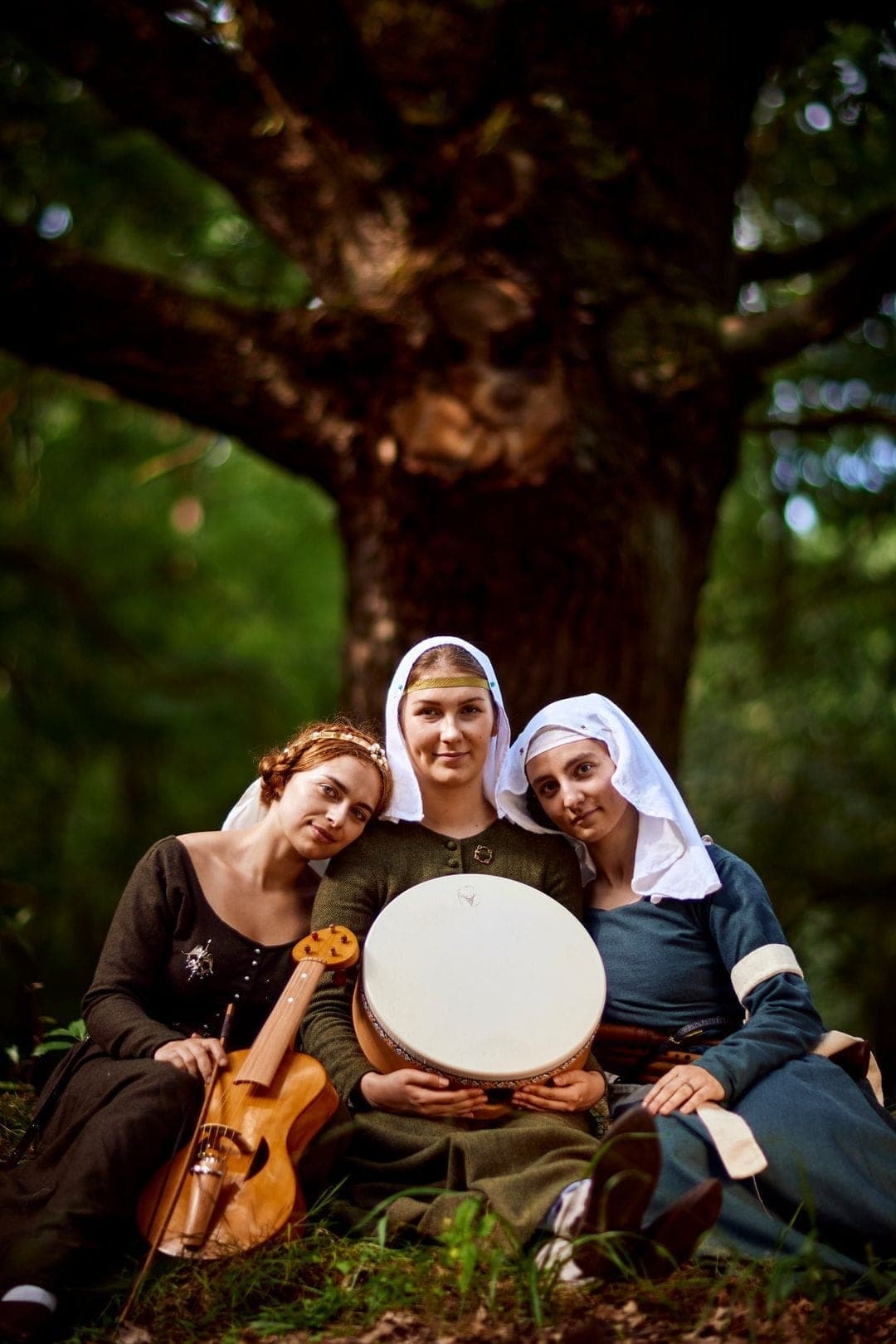 Three musicians with instruments in the forest