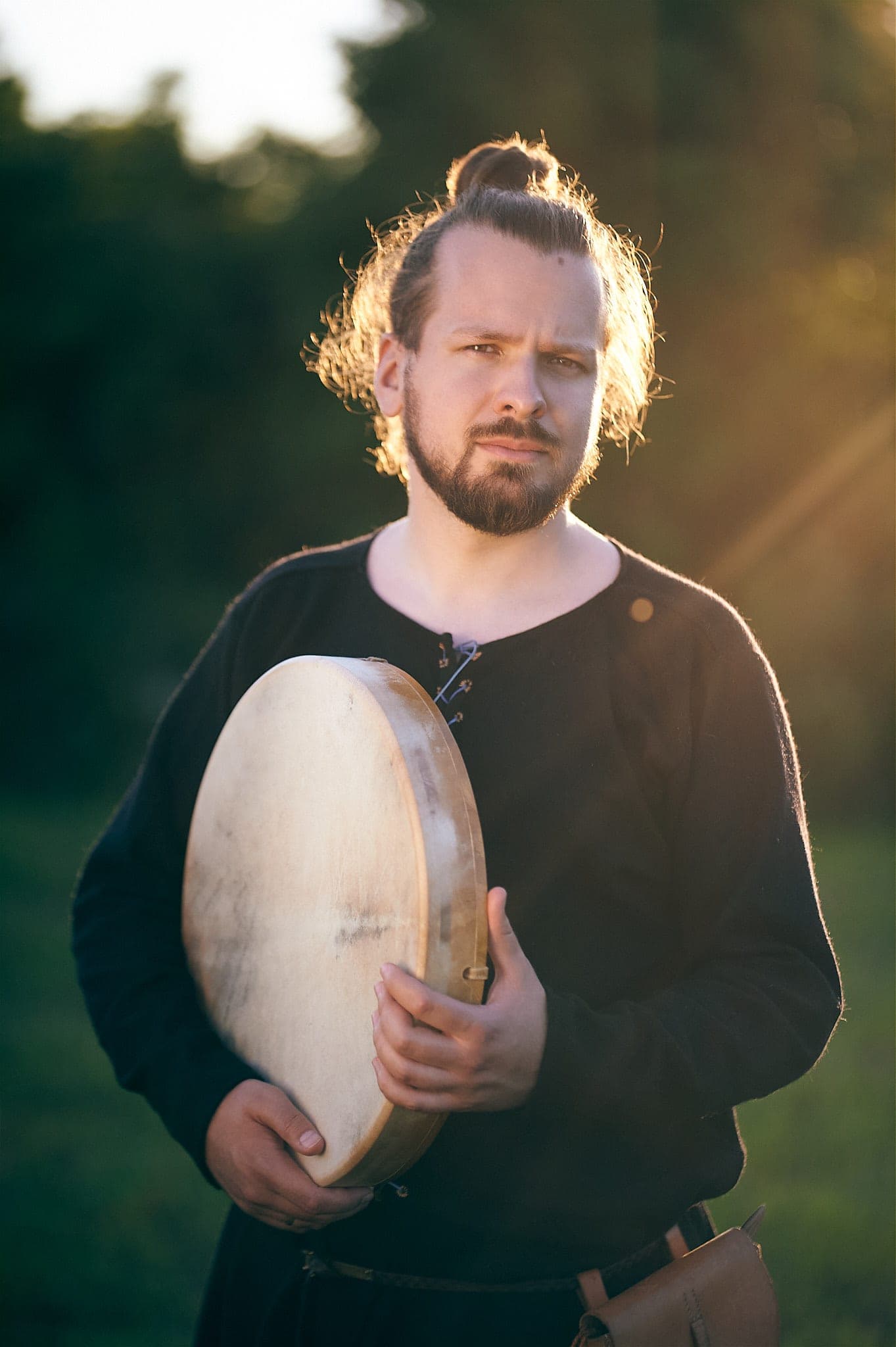 Percussionist with a frame drum at sunset